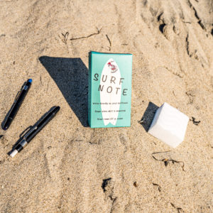 Surf Note package in the sand